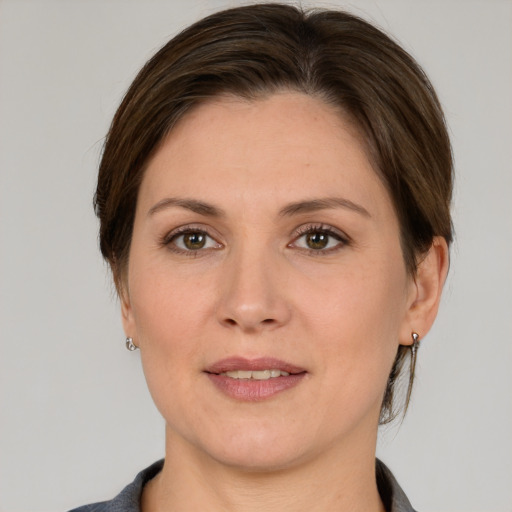 Joyful white adult female with medium  brown hair and grey eyes