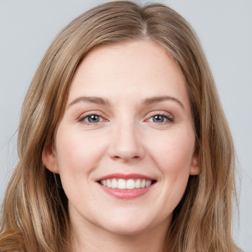 Joyful white young-adult female with long  brown hair and grey eyes