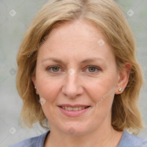 Joyful white adult female with medium  brown hair and blue eyes