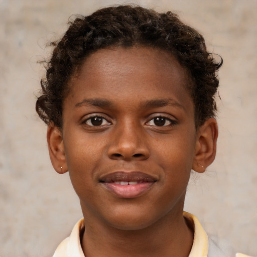 Joyful black child male with short  brown hair and brown eyes