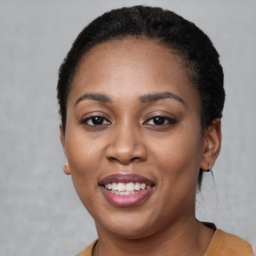 Joyful latino young-adult female with short  black hair and brown eyes