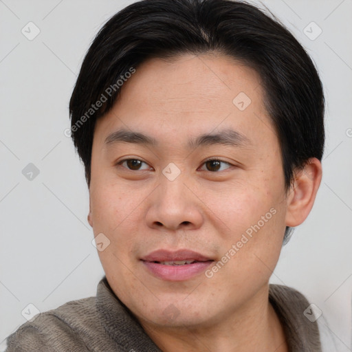 Joyful asian young-adult male with short  brown hair and brown eyes