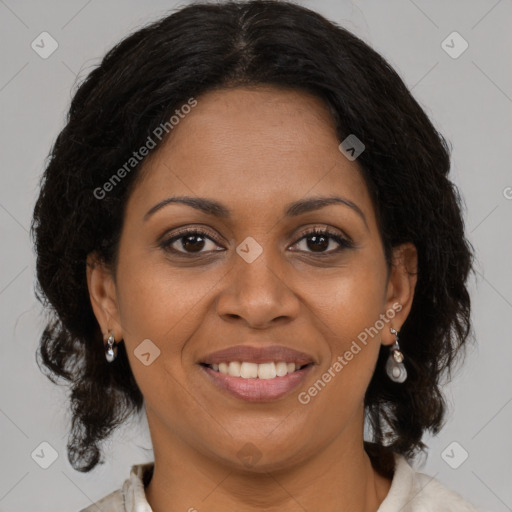 Joyful black adult female with medium  brown hair and brown eyes