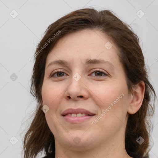 Joyful white adult female with medium  brown hair and brown eyes