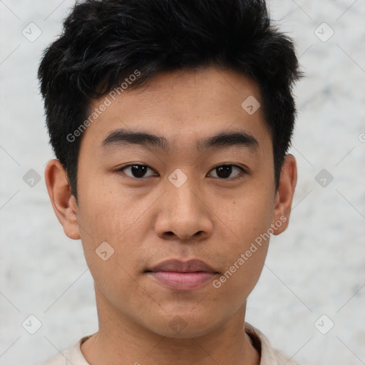 Joyful asian young-adult male with short  black hair and brown eyes