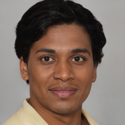 Joyful asian young-adult male with short  brown hair and brown eyes