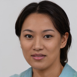 Joyful asian young-adult female with medium  brown hair and brown eyes