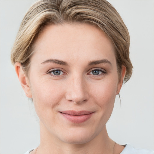 Joyful white young-adult female with short  brown hair and grey eyes