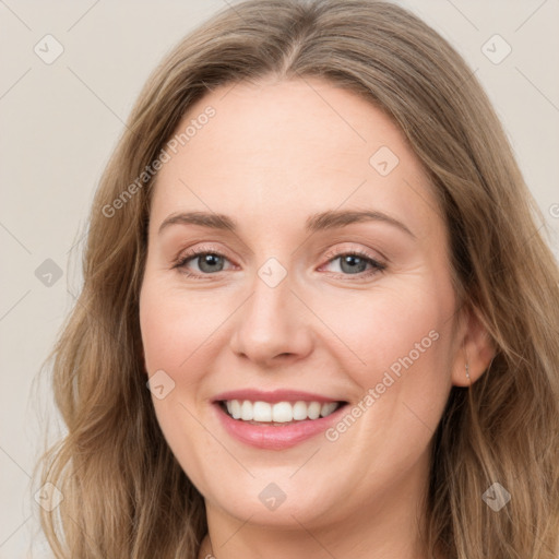 Joyful white young-adult female with long  brown hair and green eyes