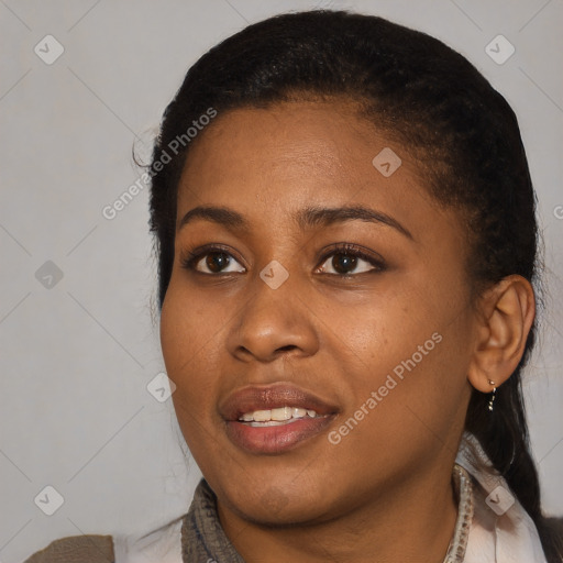 Joyful black young-adult female with short  black hair and brown eyes