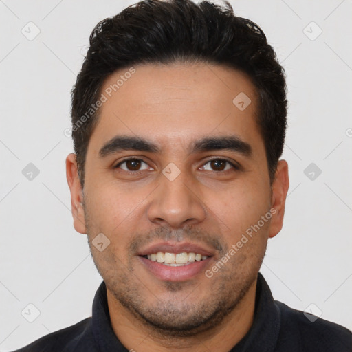 Joyful latino young-adult male with short  black hair and brown eyes