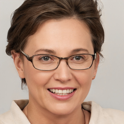 Joyful white adult female with short  brown hair and grey eyes