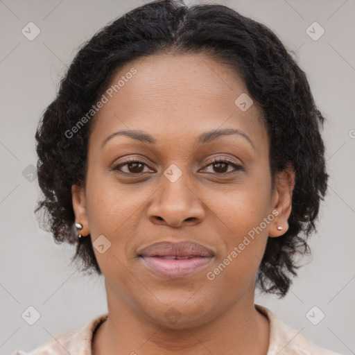 Joyful black adult female with medium  brown hair and brown eyes