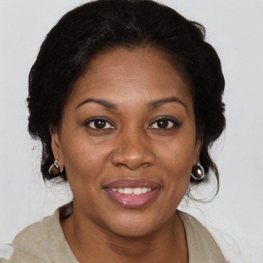 Joyful black young-adult female with medium  brown hair and brown eyes