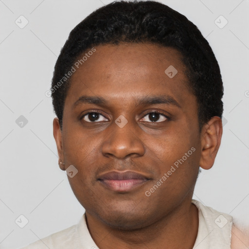 Joyful black young-adult male with short  black hair and brown eyes