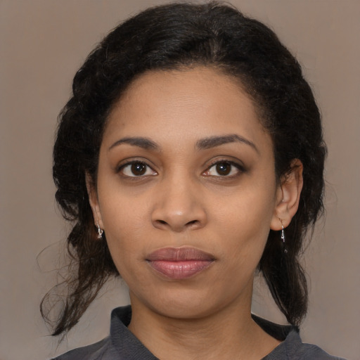 Joyful black young-adult female with medium  black hair and brown eyes