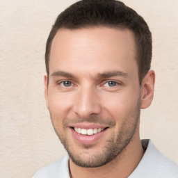 Joyful white young-adult male with short  brown hair and brown eyes