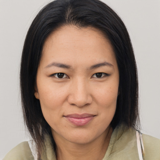 Joyful asian young-adult female with medium  brown hair and brown eyes
