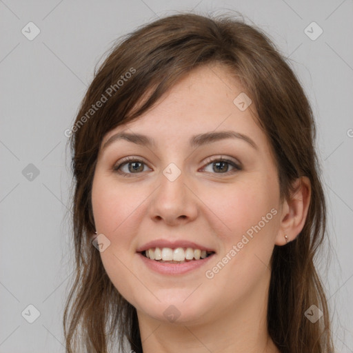 Joyful white young-adult female with long  brown hair and grey eyes