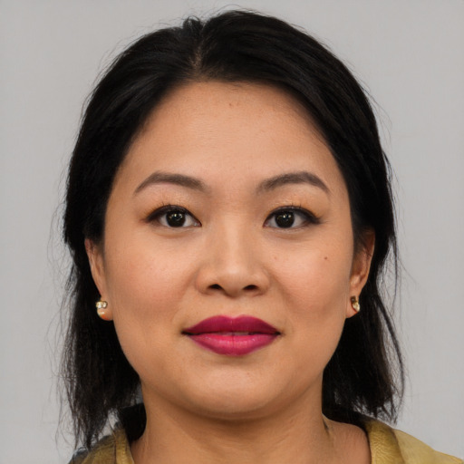 Joyful asian young-adult female with medium  brown hair and brown eyes