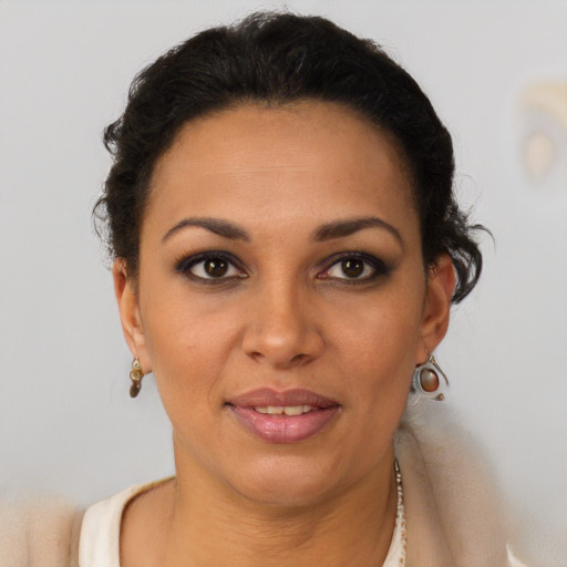 Joyful black young-adult female with short  brown hair and brown eyes