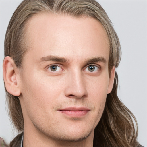 Neutral white young-adult male with long  brown hair and blue eyes