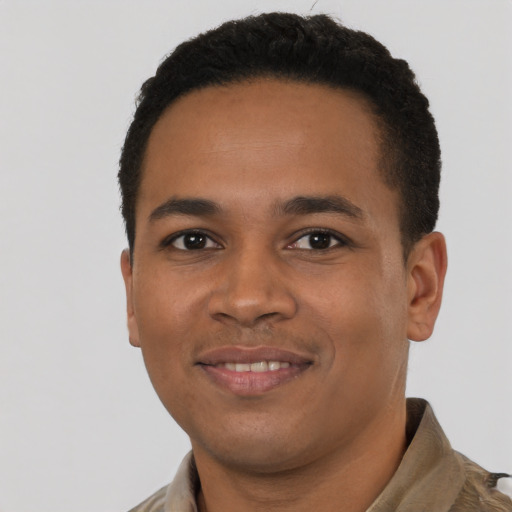 Joyful latino young-adult male with short  black hair and brown eyes