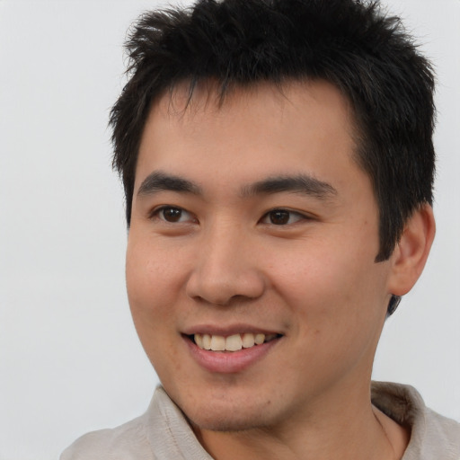 Joyful latino young-adult male with short  brown hair and brown eyes