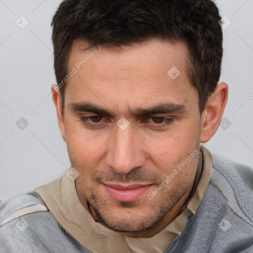 Joyful white adult male with short  brown hair and brown eyes