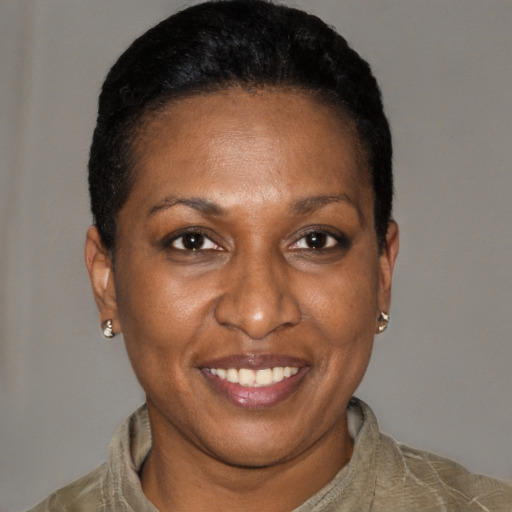Joyful black adult female with short  brown hair and brown eyes
