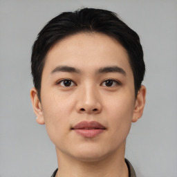 Joyful asian young-adult male with short  black hair and brown eyes