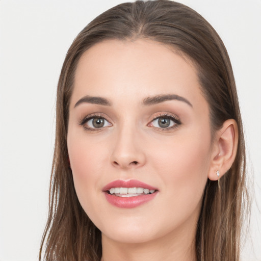 Joyful white young-adult female with long  brown hair and grey eyes