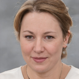 Joyful white adult female with medium  brown hair and grey eyes