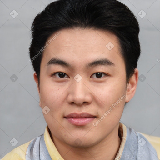 Joyful asian young-adult male with short  black hair and brown eyes