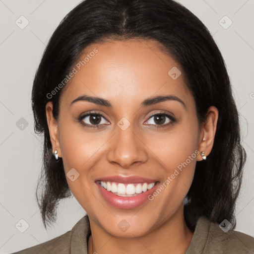 Joyful latino young-adult female with medium  brown hair and brown eyes