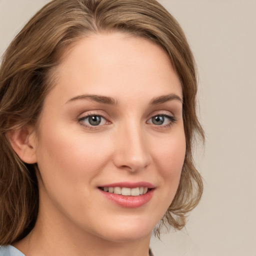 Joyful white young-adult female with medium  brown hair and green eyes