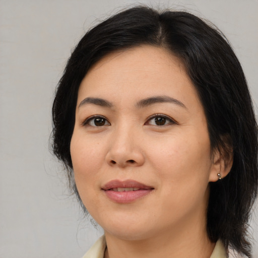 Joyful asian young-adult female with medium  brown hair and brown eyes