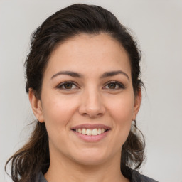 Joyful white young-adult female with medium  brown hair and brown eyes