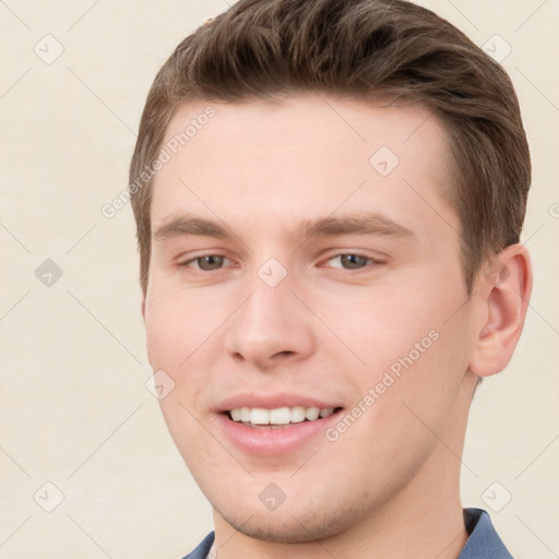 Joyful white young-adult male with short  brown hair and grey eyes