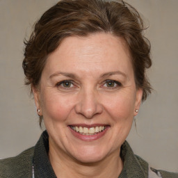 Joyful white adult female with medium  brown hair and blue eyes