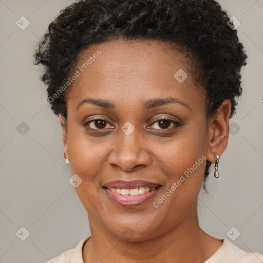 Joyful black young-adult female with short  brown hair and brown eyes