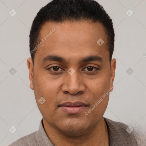 Joyful latino young-adult male with short  black hair and brown eyes