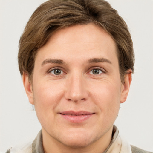 Joyful white adult female with short  brown hair and grey eyes