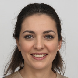 Joyful white young-adult female with medium  brown hair and brown eyes