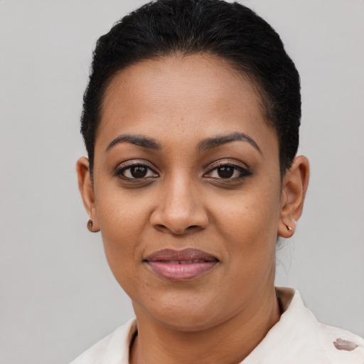 Joyful latino young-adult female with short  black hair and brown eyes
