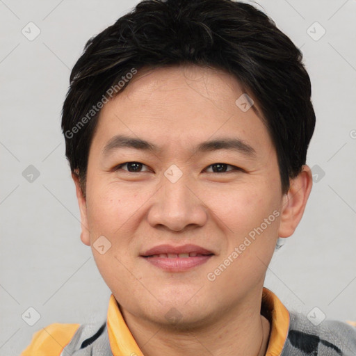 Joyful asian young-adult male with short  brown hair and brown eyes