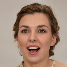 Joyful white adult female with medium  brown hair and brown eyes