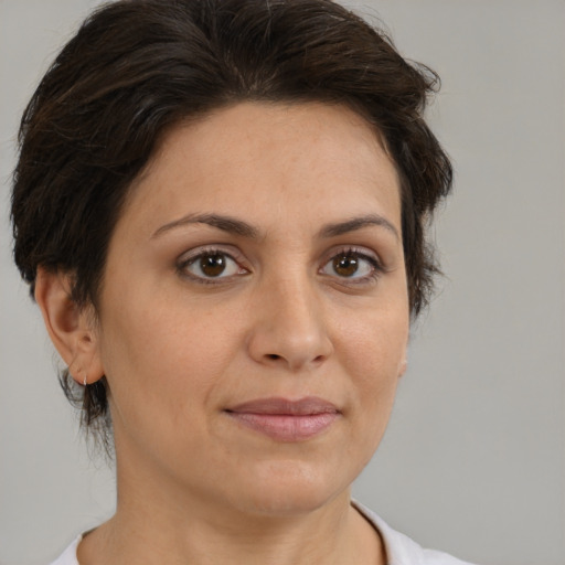 Joyful white adult female with medium  brown hair and brown eyes