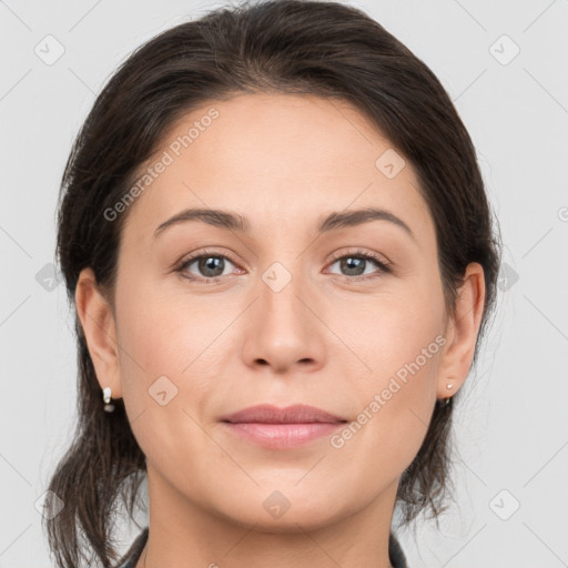 Joyful white young-adult female with medium  brown hair and grey eyes