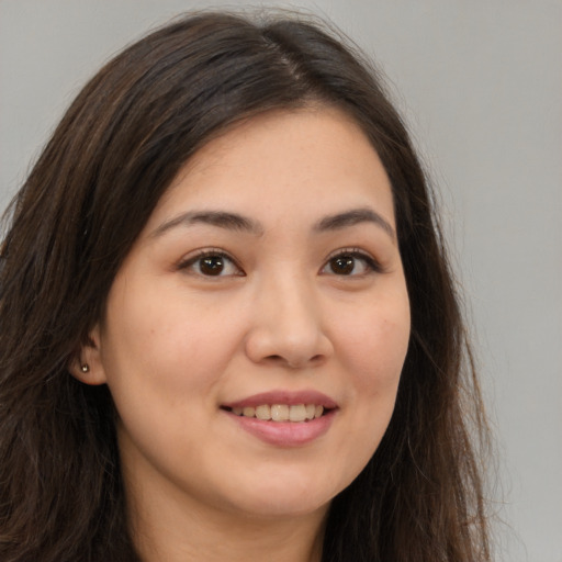Joyful white young-adult female with long  brown hair and brown eyes